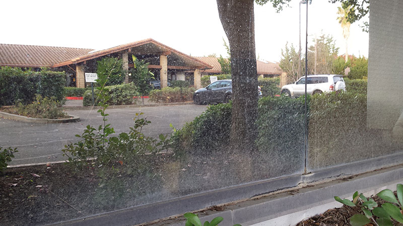 Picture of window before commercial window cleaning in Irvine by Blue Coast Window Cleaning Service.